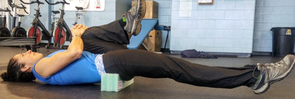 Person performing a plank exercise with feet elevated on a box.